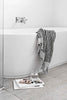 Black and white striped bathroom set with bath mat