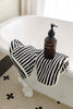 Black and white striped bathroom set with bath sheets, mat, and hand towel