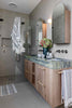 Eucalyptus Bathroom Set with blue, green and white woven bath mat and towels featuring a checked pattern and tassels