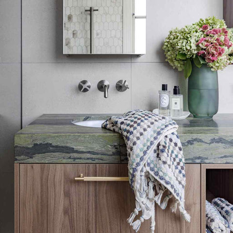 Eucalyptus Bathroom Set featuring a plush Turkish cotton towel in soft green, blue, grey and white geometric pattern with tassels