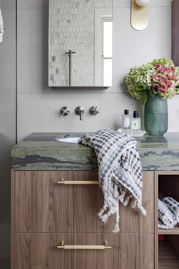 Eucalyptus Bathroom Set featuring a plush Turkish cotton towel in soft green, blue, grey and white geometric pattern with tassels