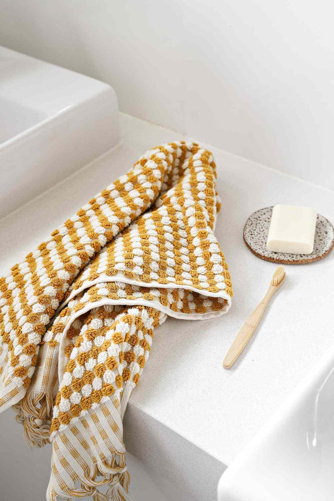 Mustard yellow Turkish cotton bathroom towel set with pompom details