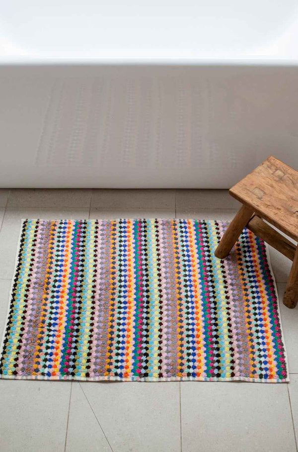 Vibrant pompom Turkish cotton bath mat in candy colours