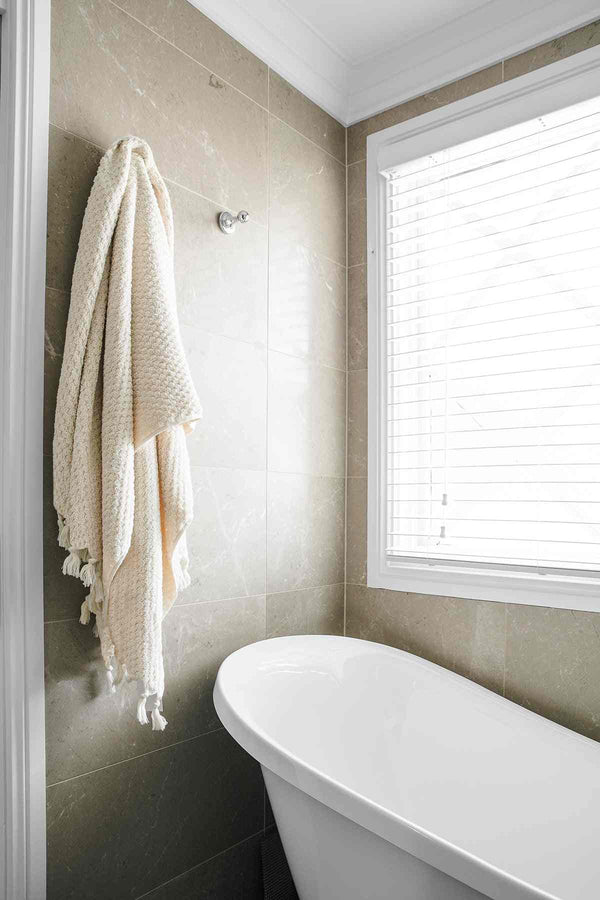 Natural beige Pompom Turkish cotton bath sheet towel draped