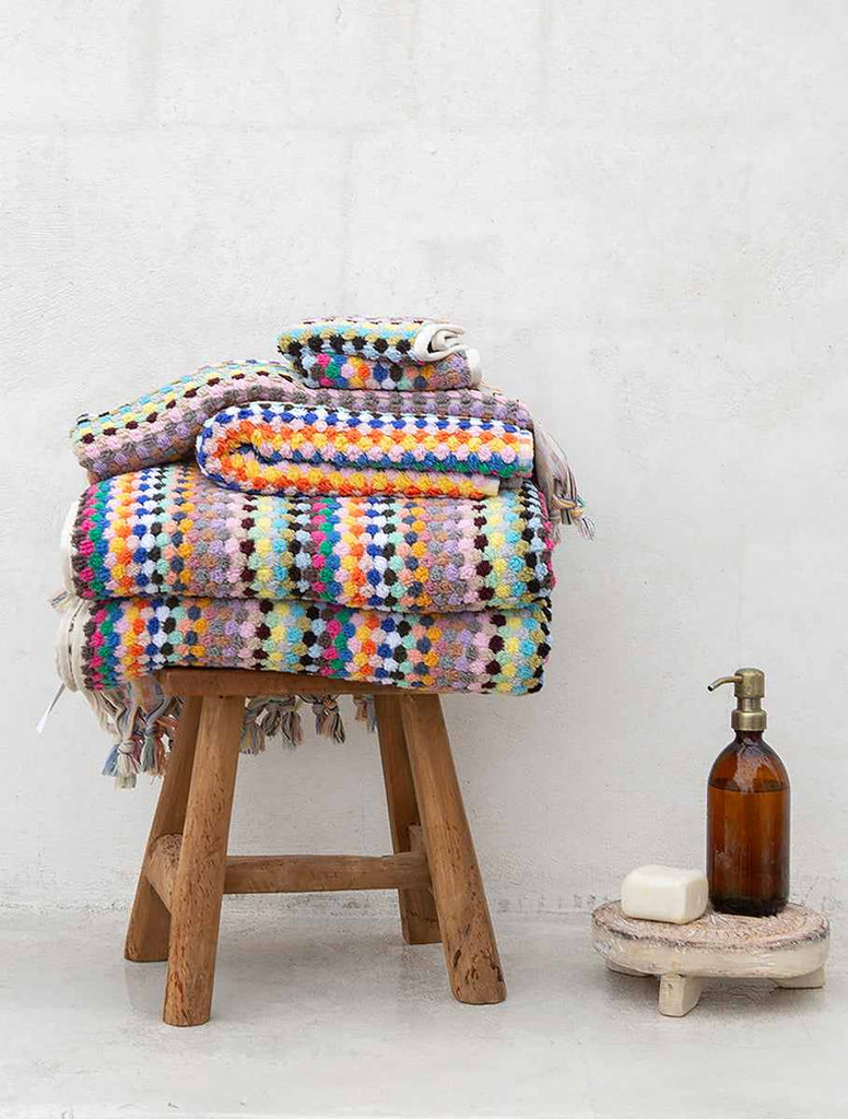 Colorful pompom Turkish cotton hand towel in candy hues with tassels