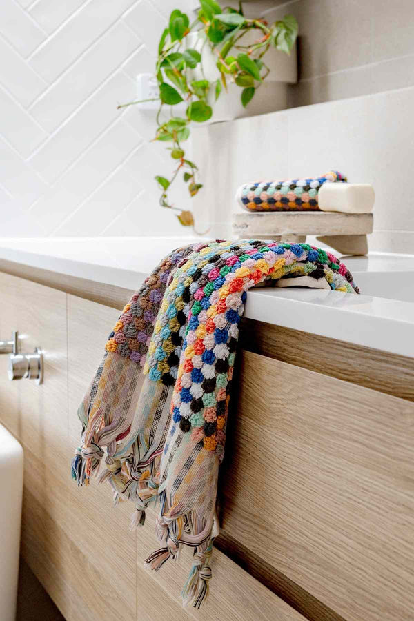 Colorful pompom Turkish cotton hand towel in candy hues