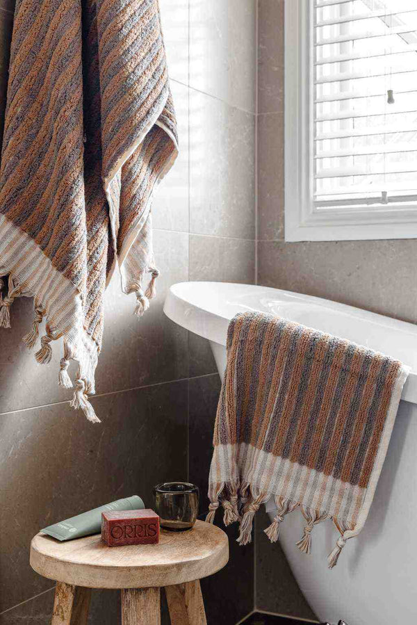 Turkish Cotton Bath Towel in warm latte and grey woven stripes, with soft texture and hand-tied tassels