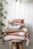 Turkish Cotton Hand Towel in pink, grey, and cream stripes, woven cotton with decorative hand-tied tassels