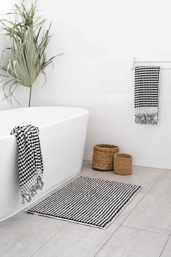 Black and white pompom Turkish cotton bath sheet in minimalist bathroom