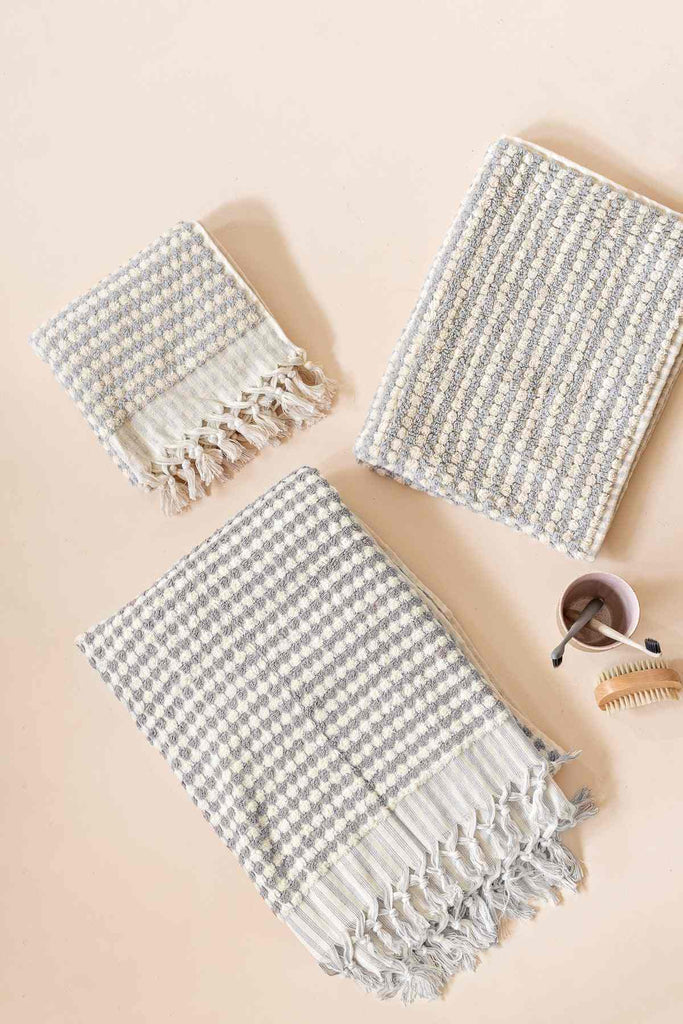 Pompom Turkish cotton bath sheet and smaller towels in pale grey with white stripes and tassels