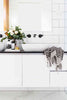 Black and white pompom Turkish cotton hand towel hanging in modern bathroom