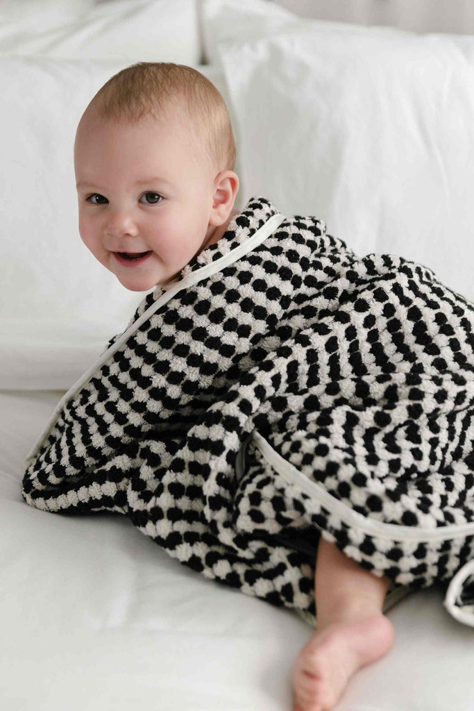 Baby wrapped in black and white pompom Turkish cotton hooded towel