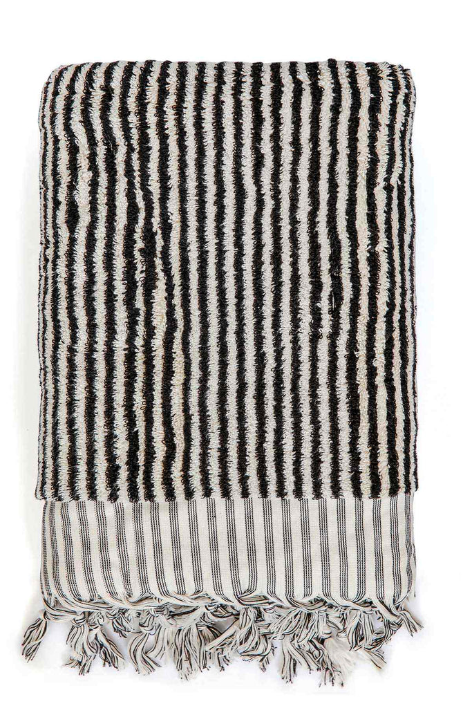 Black and white striped Turkish cotton bath sheet folded neatly